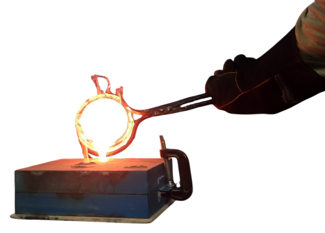 Pouring molten bronze from a hot, glowing crucible