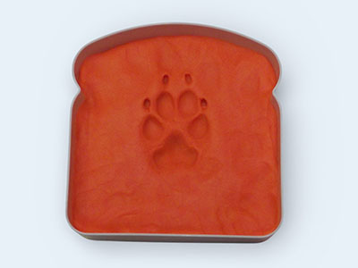 An impression of a dog paw in red Play-Doh.